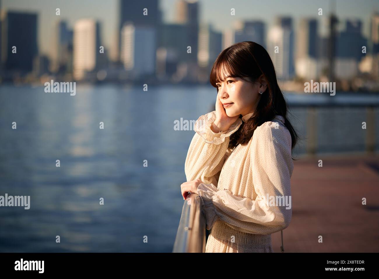 Japanese woman in a white dress standing near the water Stock Photo - Alamy