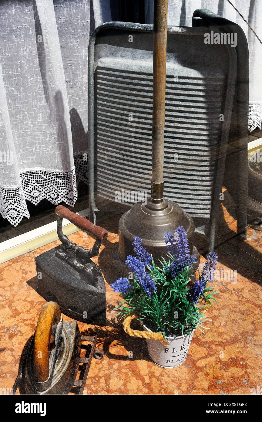 Shop window of a laundry with washboard, old iron and laundry tamper, Kempten, Allgaeu, Bavaria, Germany Stock Photo