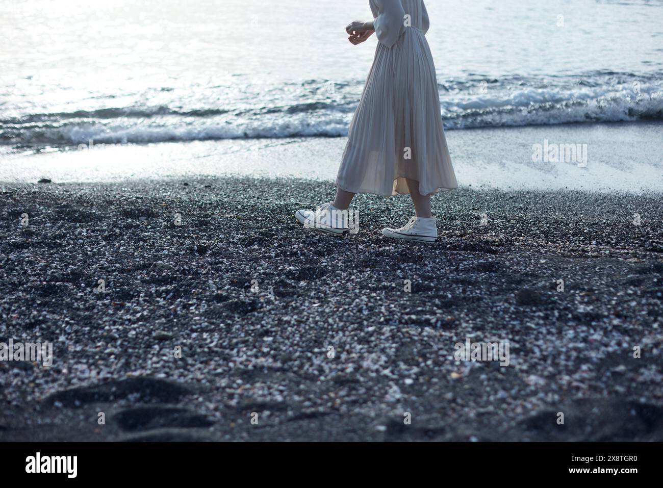 Japanese woman in a white dress walking on the beach Stock Photo - Alamy
