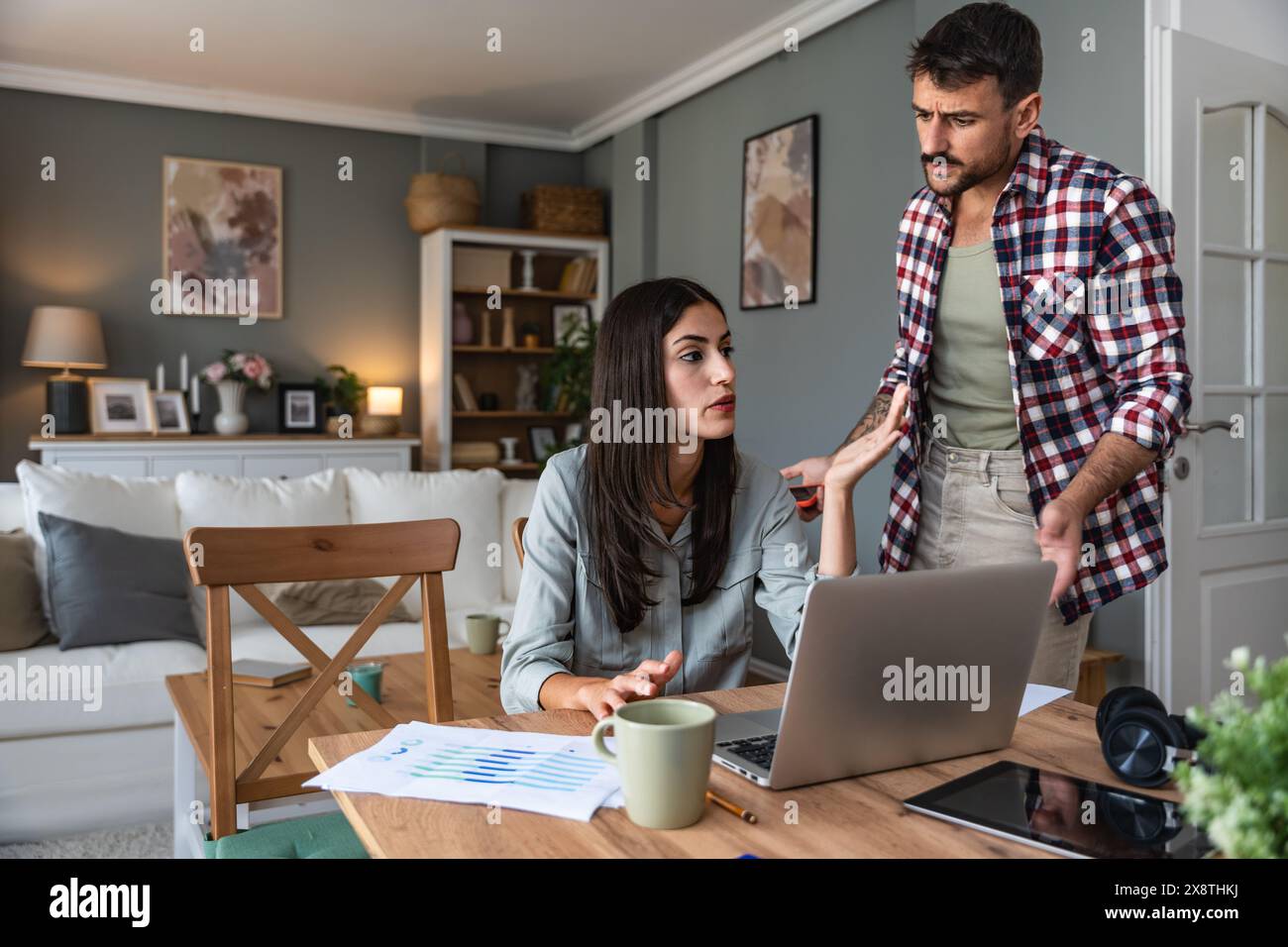 Young couple, freelancers small internet business owners, professional designers, computer software developers, working together at home, on new proje Stock Photo
