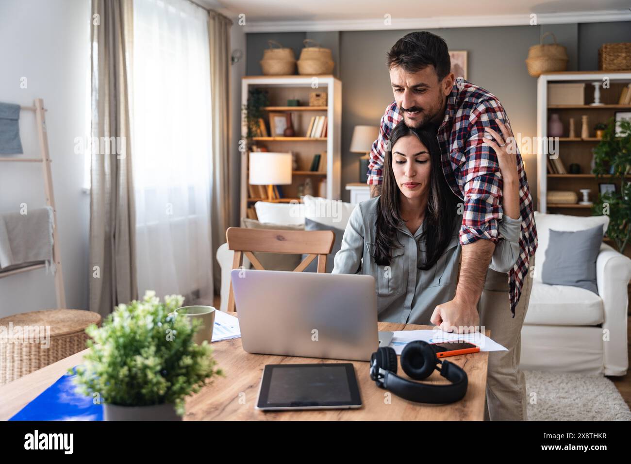 Young couple, freelancers small internet business owners, professional designers, computer software developers, working together at home, on new proje Stock Photo
