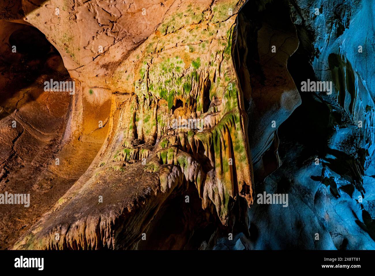 Stalactites and stalagmites dominate the scene in the dimly lit caverns ...