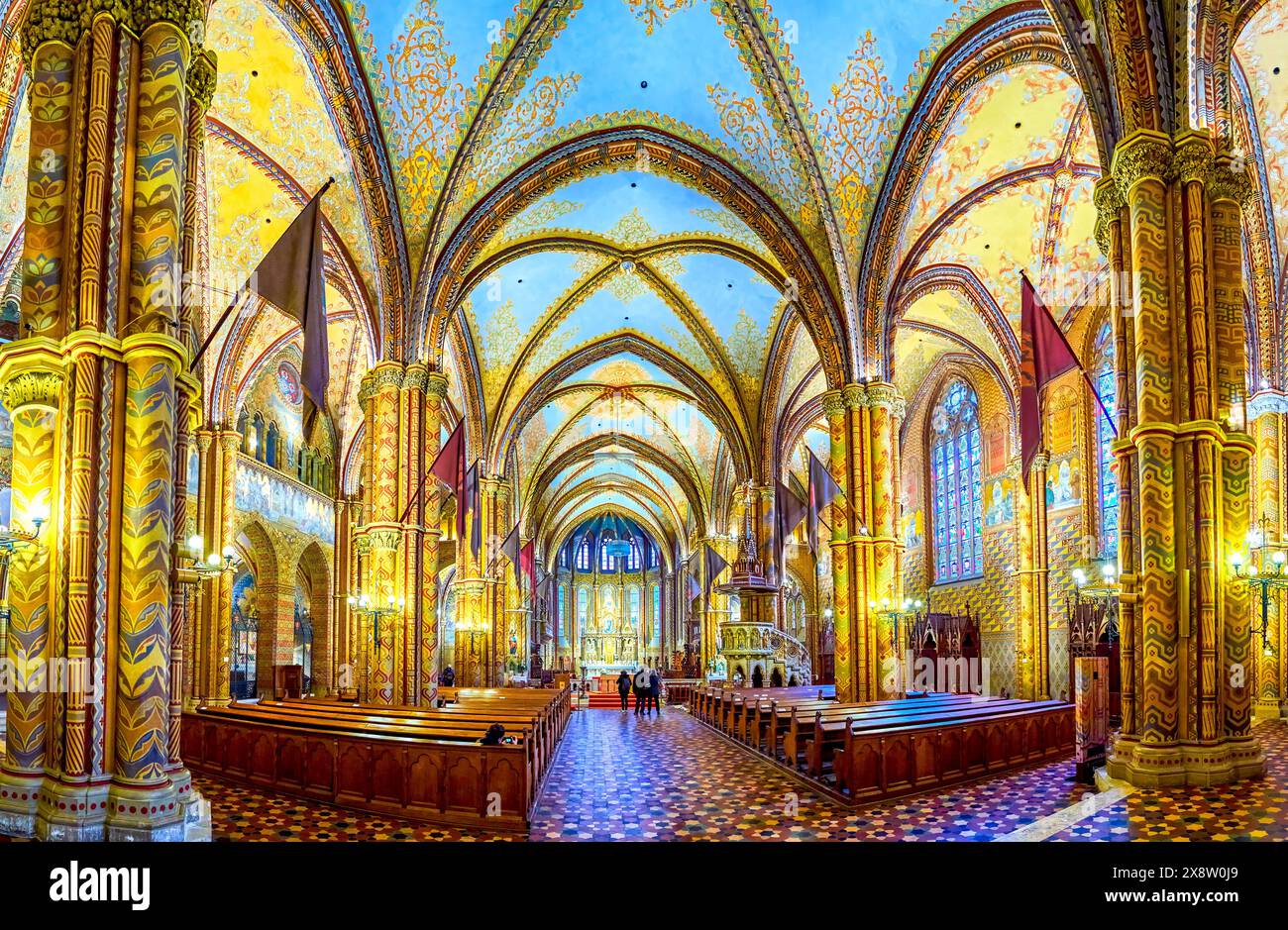 BUDAPEST, HUNGARY - FEBRUARY 28, 2022: Panorama of historic Matthias Church, decorated with frescoes, carvings, gilt patterns, on February 21 in Budap Stock Photo