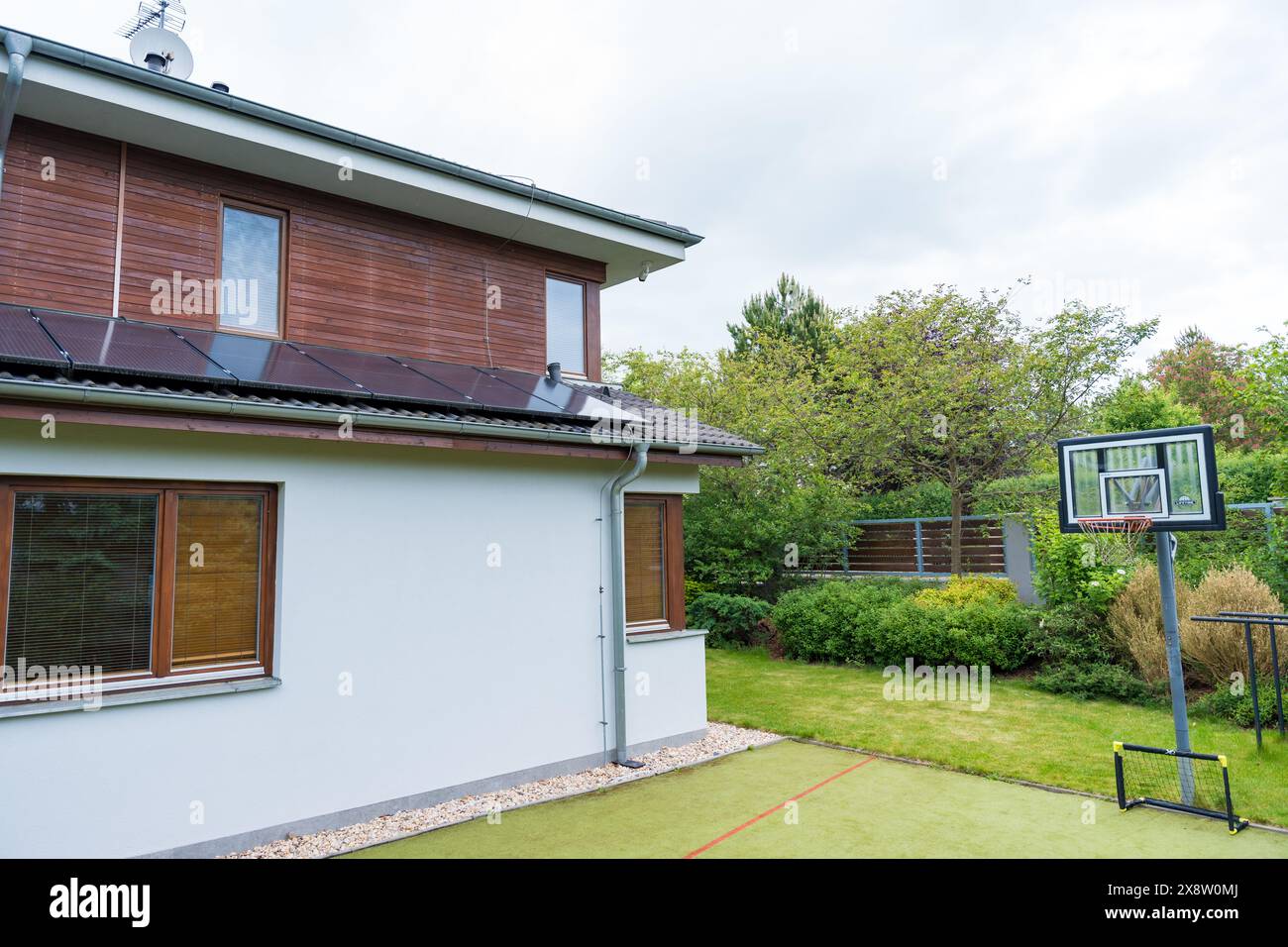 Solar panels on residential roof: eco-friendly energy solutions and sustainable living concepts Stock Photo