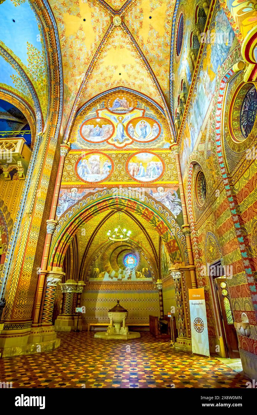 BUDAPEST, HUNGARY - FEBRUARY 28, 2022: Panoramic view on the interior of Matthias Church with carved rib-vaulted ceiling, columns, stained-glass windo Stock Photo