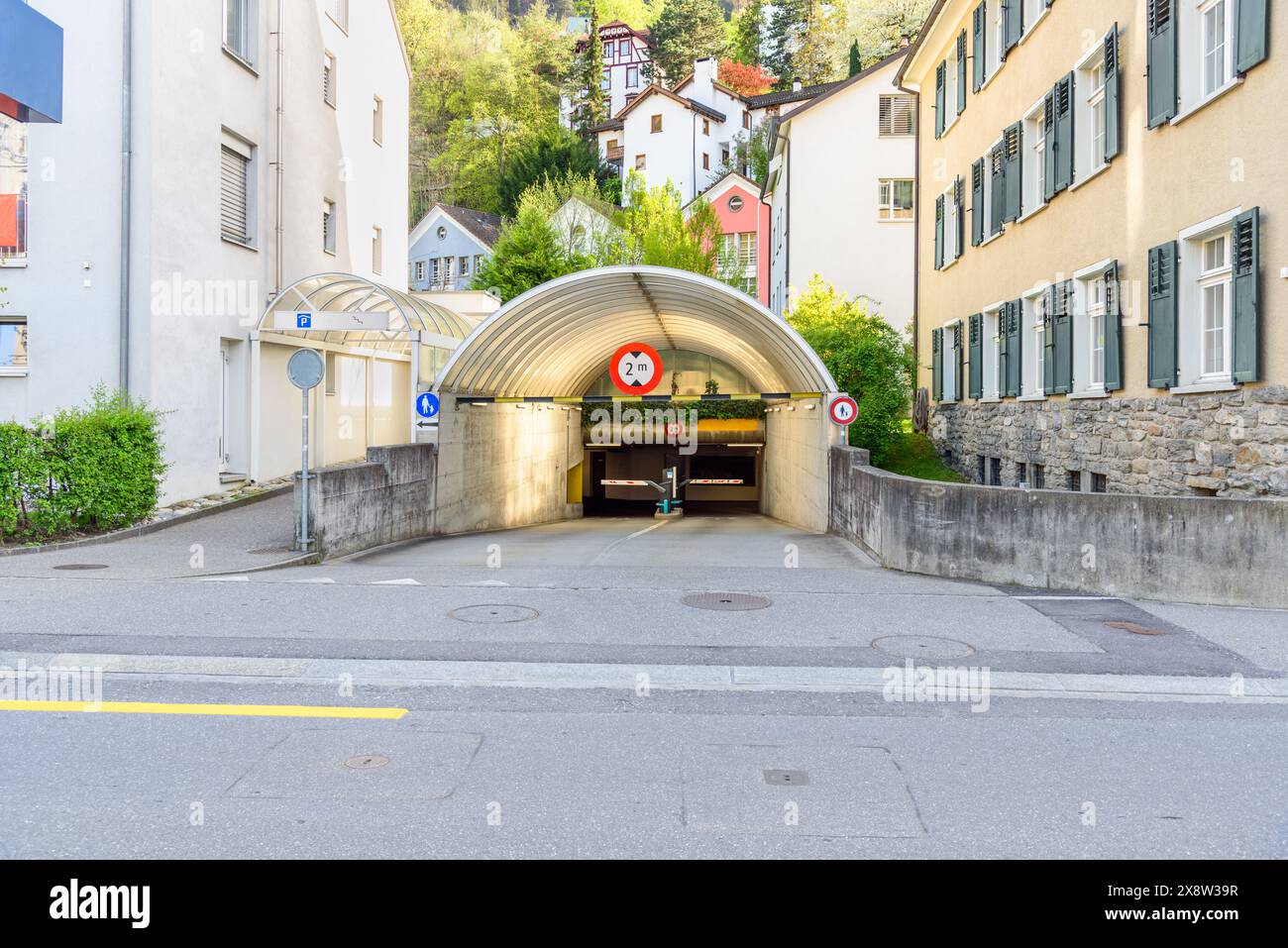 Entrance of an underground parking garage in a city centre at sunset in spring Stock Photo