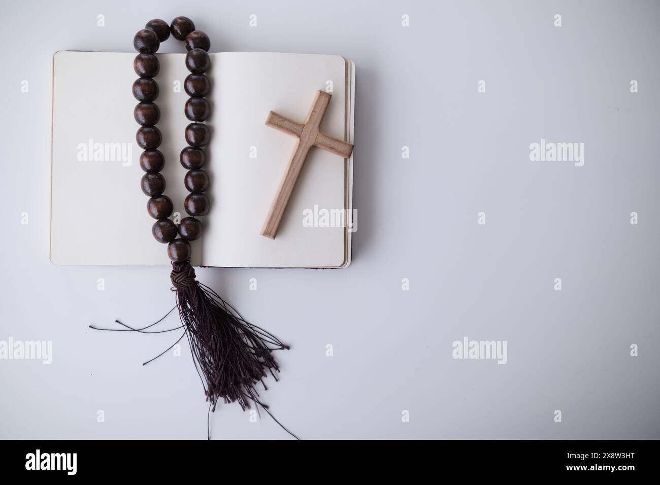 cross is placed on the Bible after prayer to God, which is religious ...