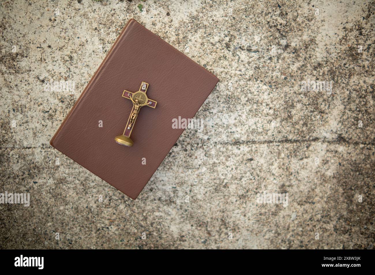 cross is placed on the Bible after prayer to God, which is religious ...