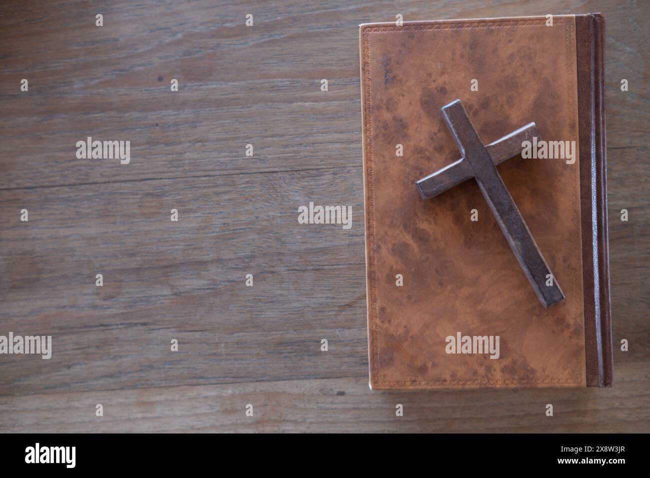 cross is placed on the Bible after prayer to God, which is religious ...
