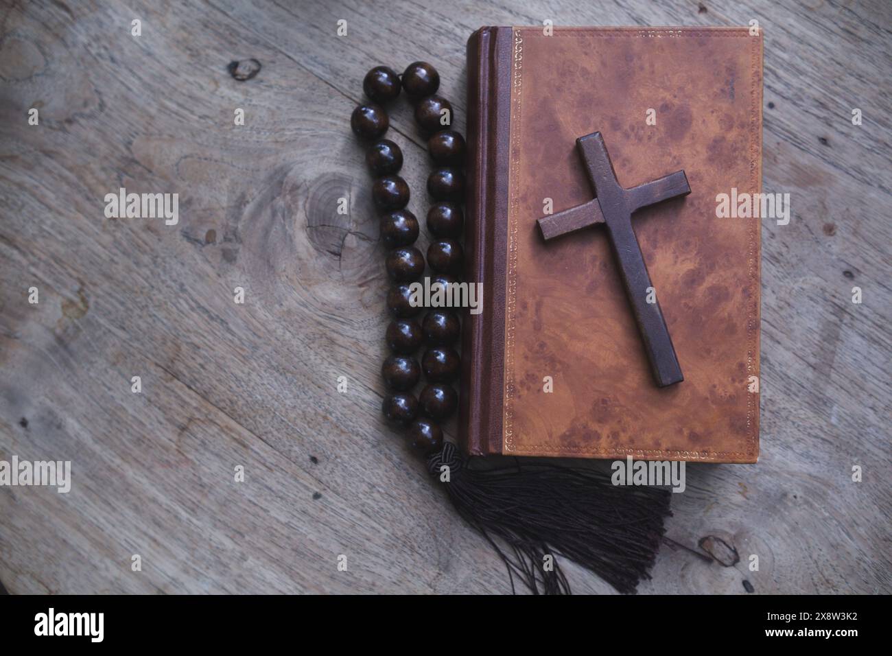 cross is placed on the Bible after prayer to God, which is religious ...