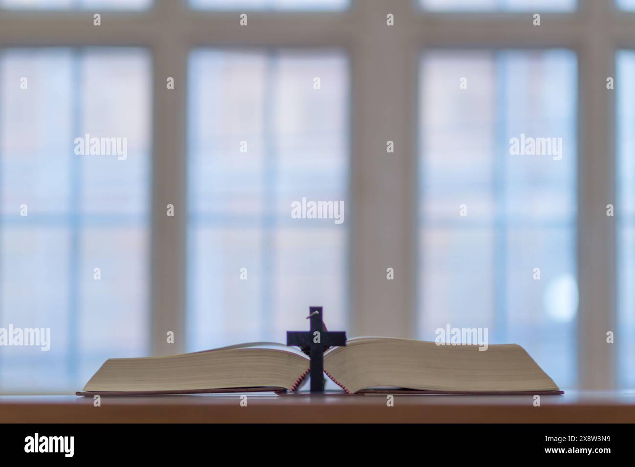 cross is placed on the Bible after prayer to God, which is religious ...