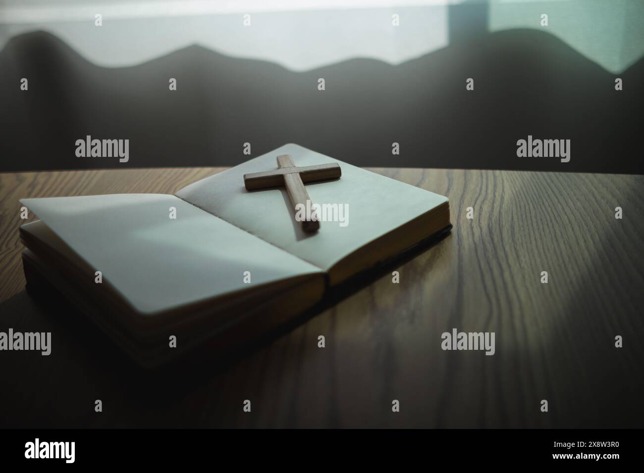 cross is placed on the Bible after prayer to God, which is religious ...