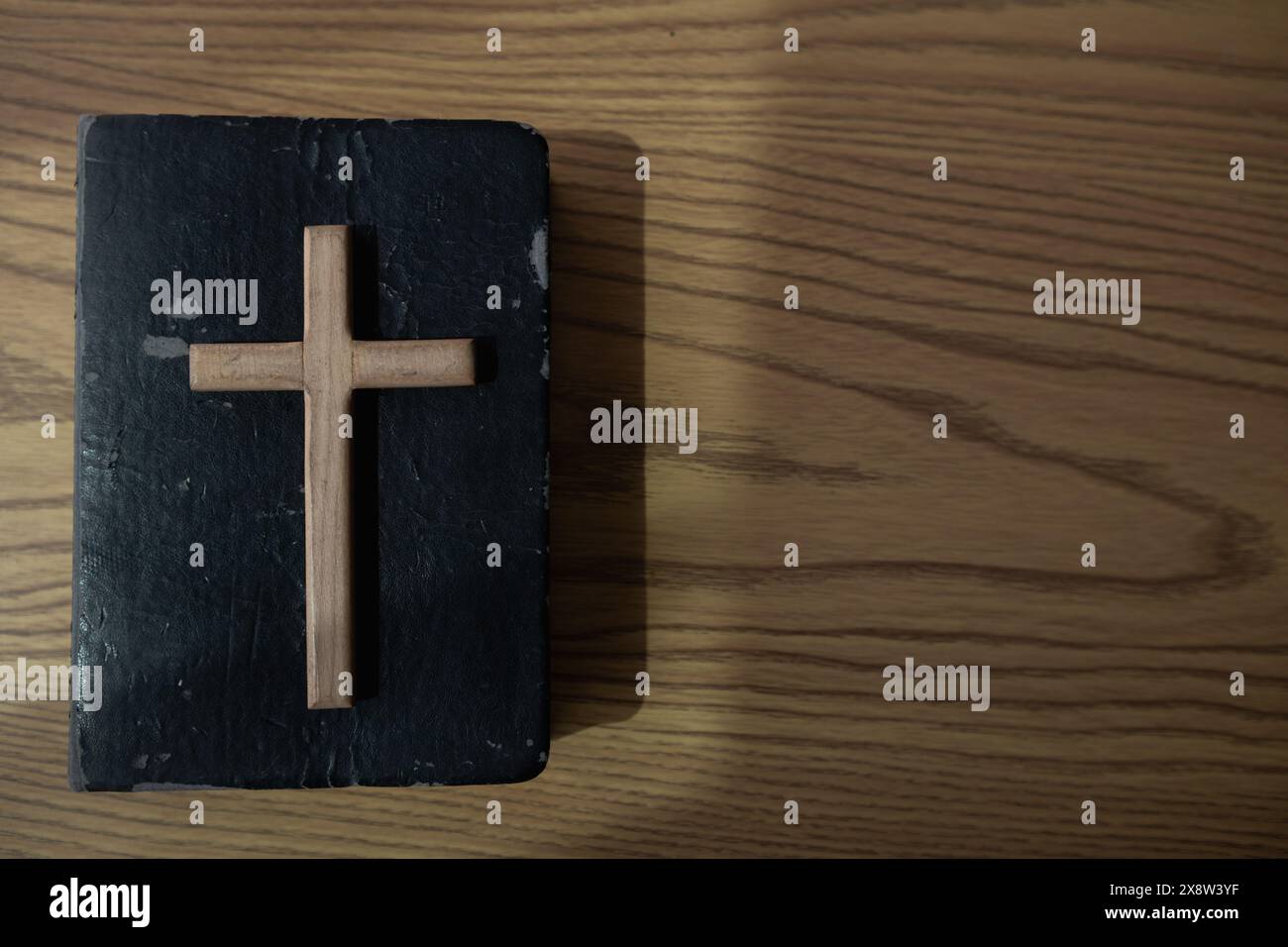 cross is placed on the Bible after prayer to God, which is religious ...