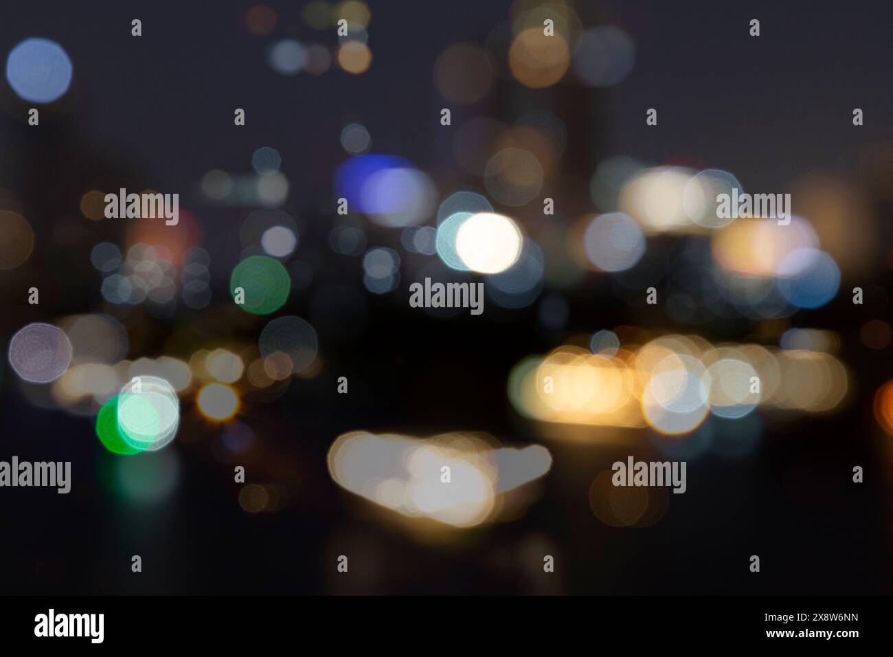 Blurred bokeh city lights, abstract night scene. Abstract high resolution full frame background with copy space. Stock Photo