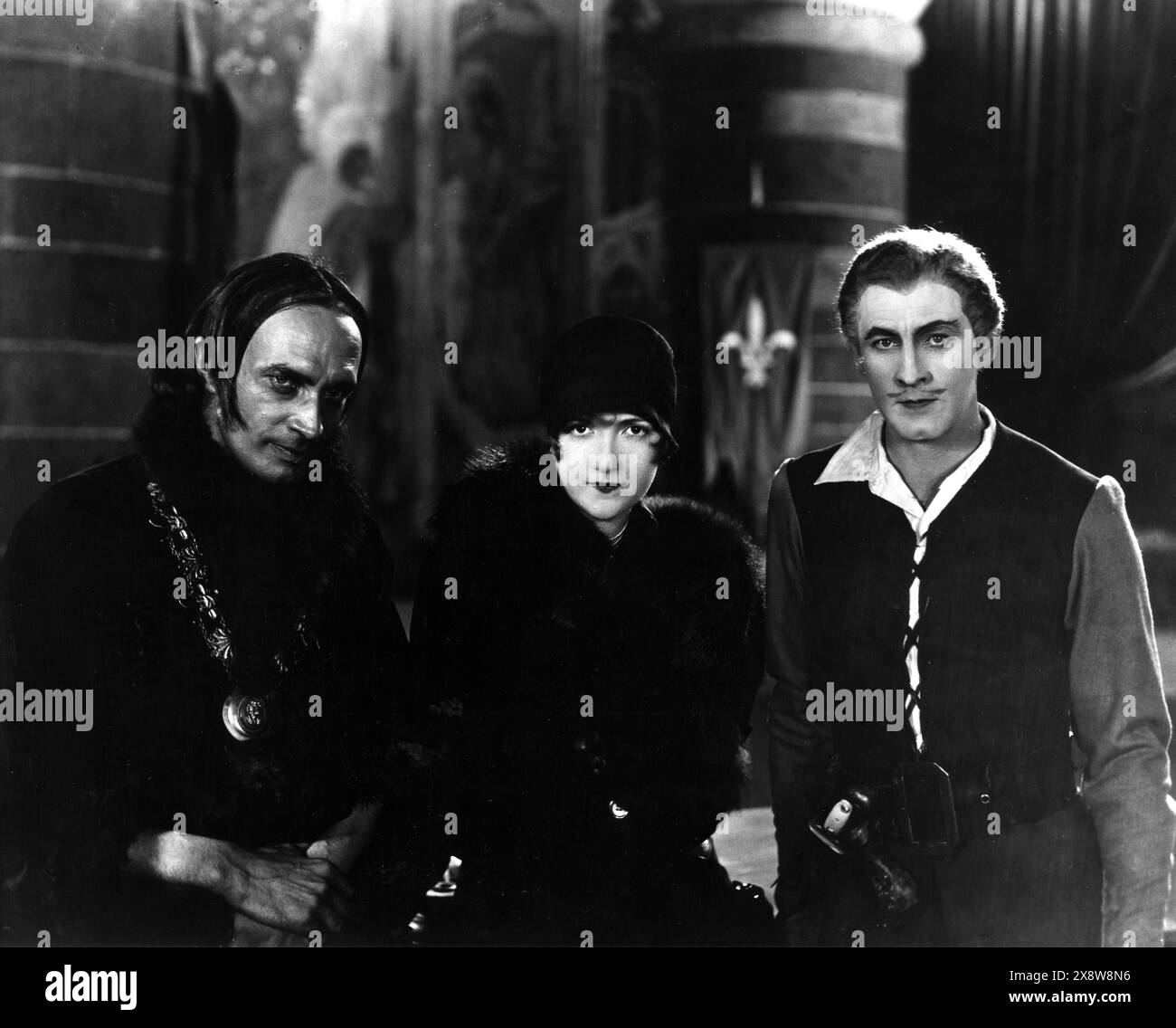CONSTANCE TALMADGE visits CONRAD VEIDT and JOHN BARRYMORE on the set of THE BELOVED ROGUE 1927 Director ALAN CROSLAND Art Direction WILLIAM CAMERON MENZIES  United Artists Stock Photo