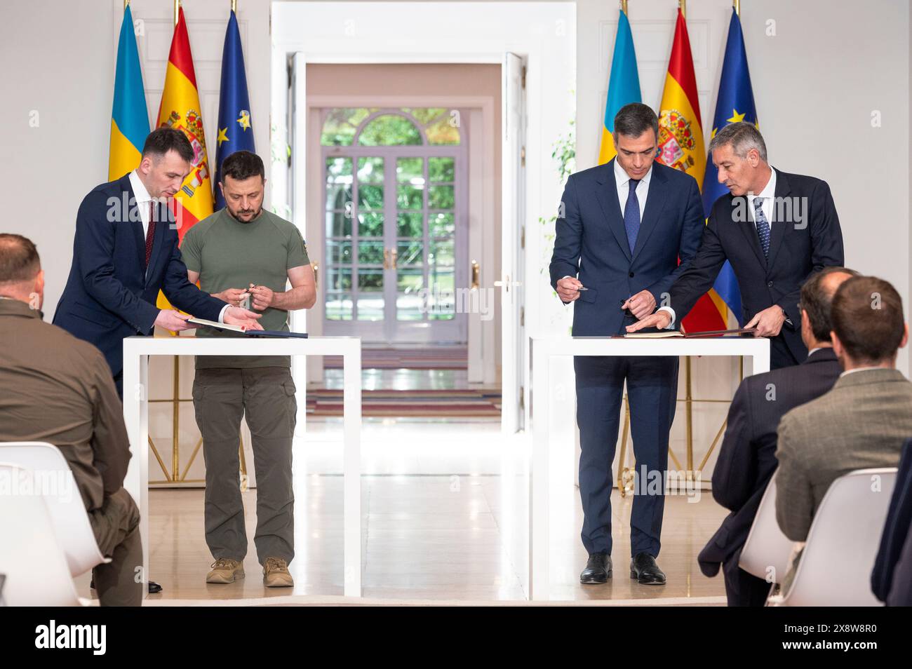 Madrid, Spain. 27th May, 2024. Ukrainian President Volodymyr Zelensky (left) and Spanish Prime Minister Pedro Sanchez (right) sign a bilateral security agreement at Moncloa Palace in Madrid. Both have signed a bilateral security agreement, which includes military supplies ranging from Patriot missiles to Leopard tanks, amounting to 1.129 billion euros. (Photo by Miguel Candela/SOPA Images/Sipa USA) Credit: Sipa USA/Alamy Live News Stock Photo