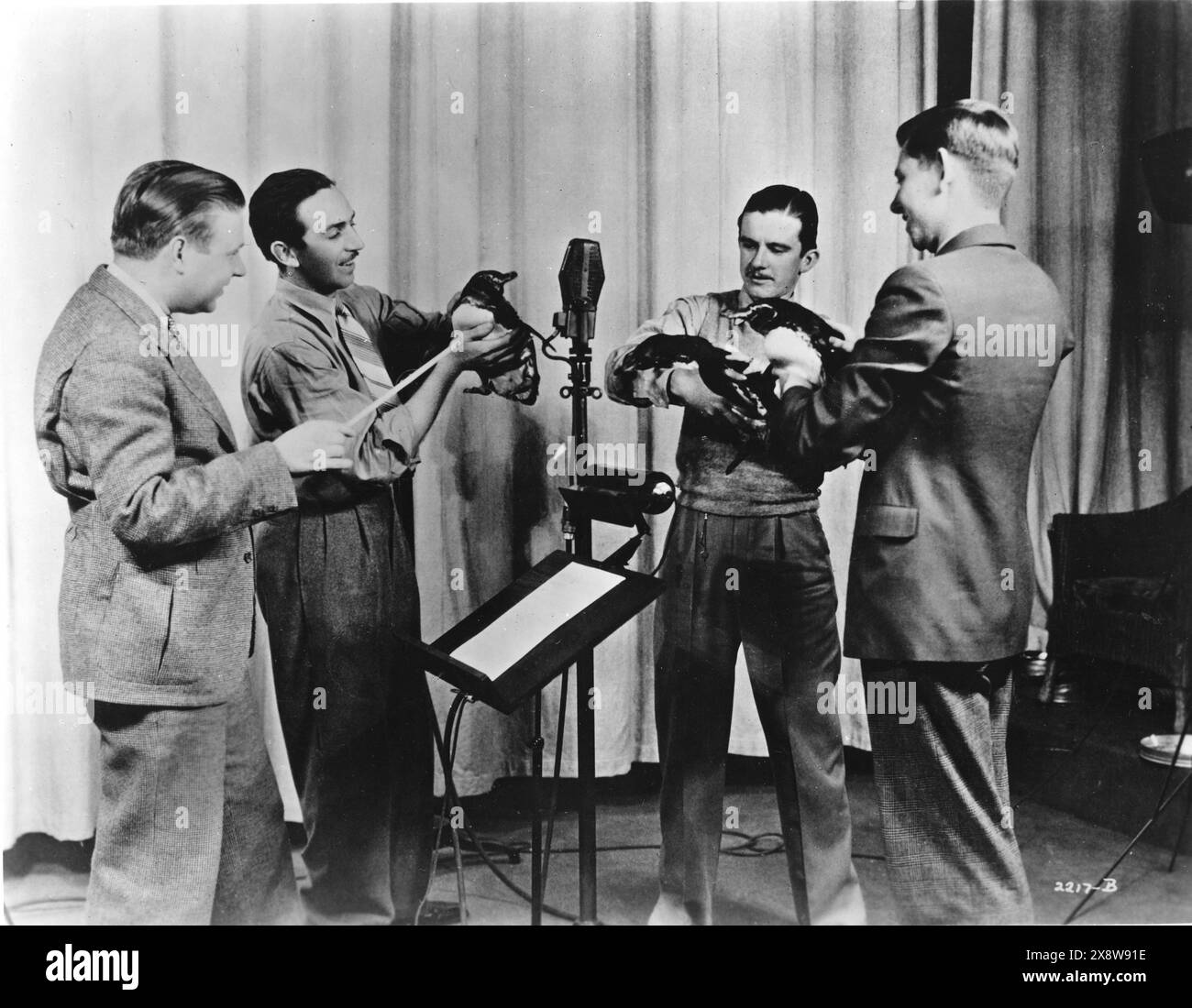 WALT DISNEY and music composer LEIGH HARLINE (on the left) recording the soundtrack for the Silly Symphony PECULIAR PENGUINS 1934 Walt Disney Productions / United Artists Stock Photo