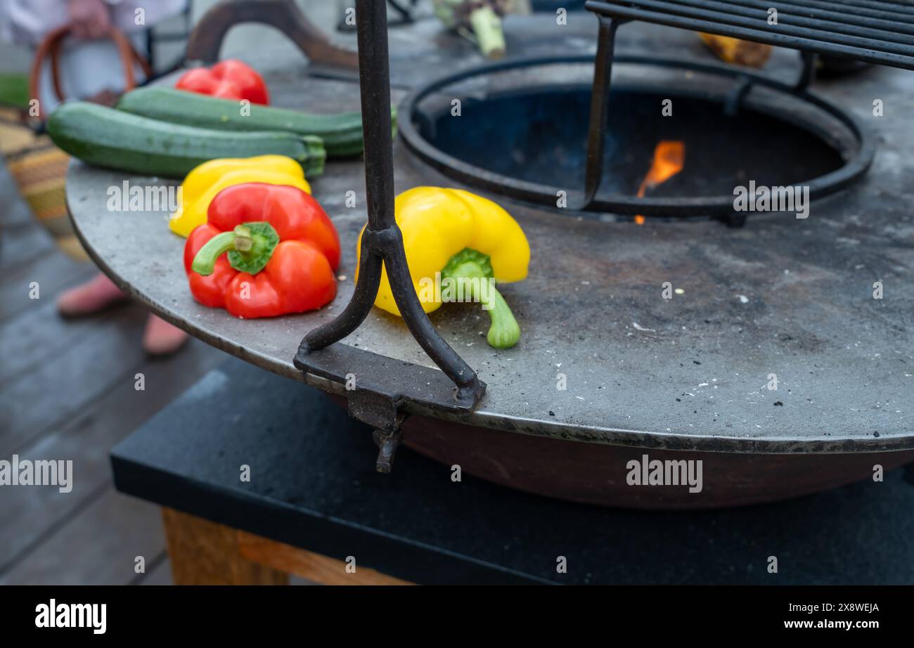Bell peppers cooking on an outdoor hotplate Stock Photo