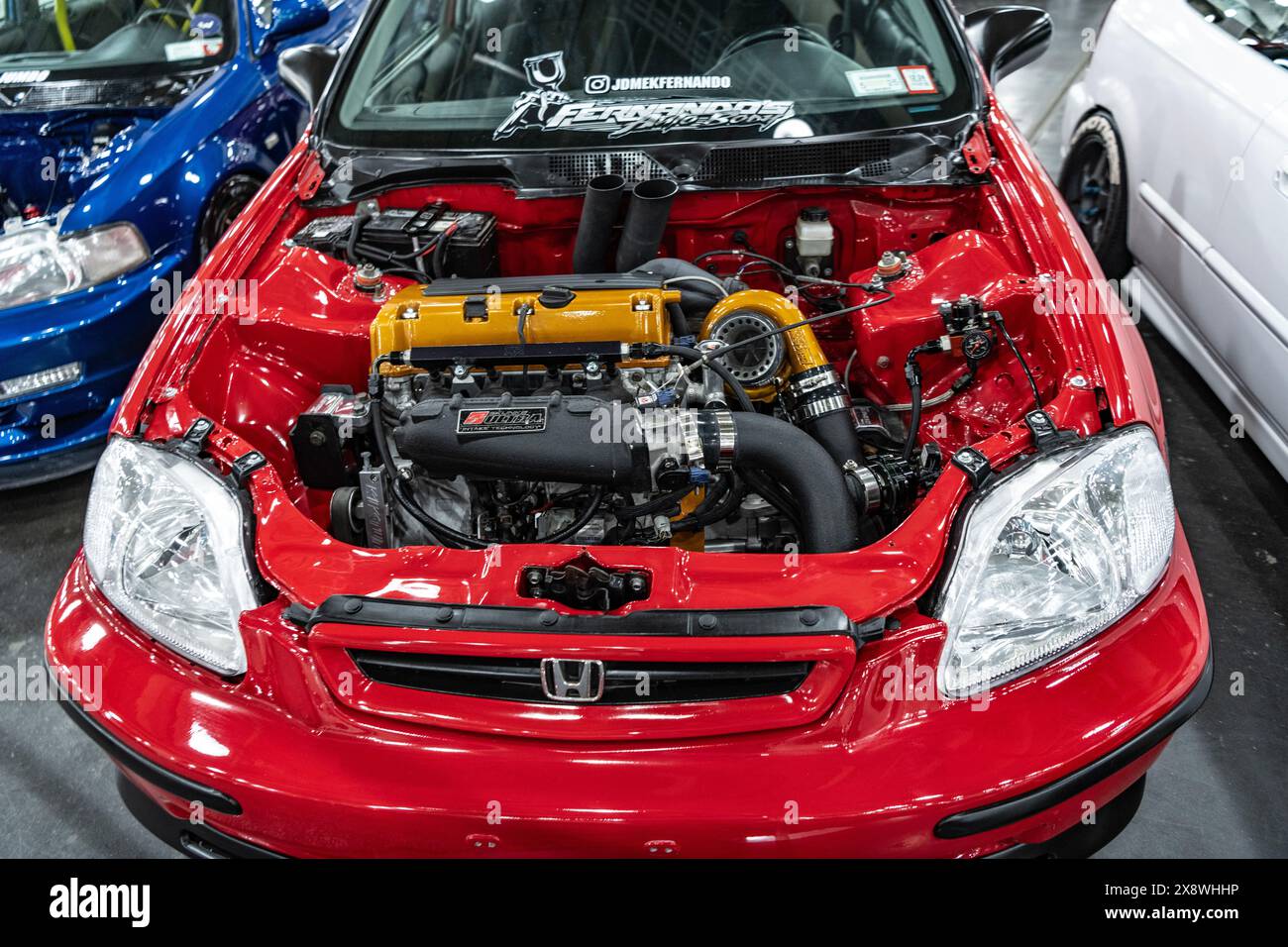 New York City, USA - March 27, 2024: Honda Civic compact red car is a vehicle size class red car with open hood with powertrain engine motor at New Stock Photo