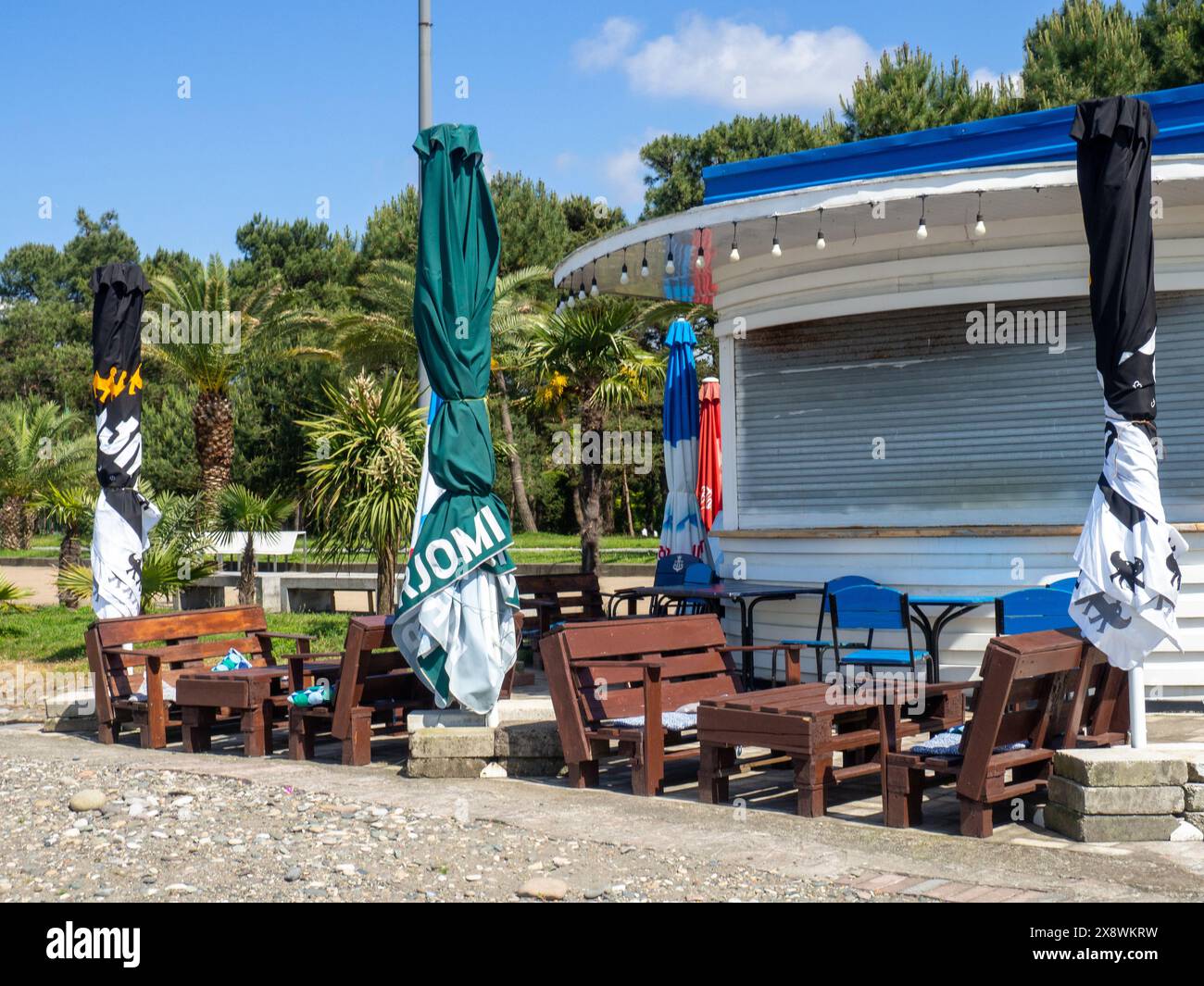 Batumi, Georgia. 05.18.2024 Closed cafe on the seashore. Folded umbrellas in a restaurant. Off-season concept. A crisis Stock Photo