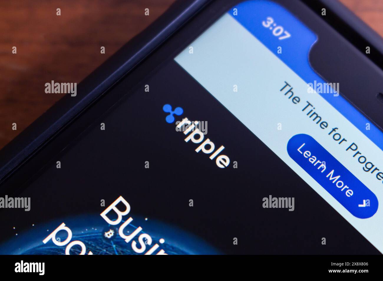 Logo of Ripple seen in an iPhone. Ripple (XRP) is a digital payment protocol and cryptocurrency that aims to facilitate international money transfers Stock Photo