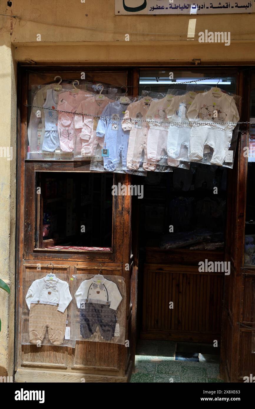Baby's clothing displaying outside of a children's clothing store in the market square in Ksar Beni Isguen.Beni Isguen is one of the 5 Ksars (fortified settlement) in Mzab valley.Ghardaia province.North Sahara.Algeria Stock Photo
