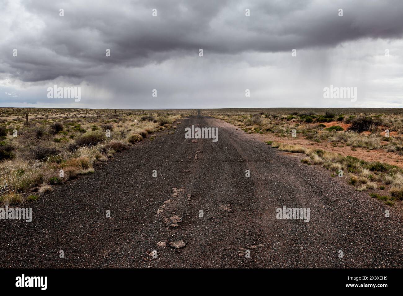 Storm clouds pass over an abandoned section of Route 66 in Eastern Arizona near Chambers. Stock Photo