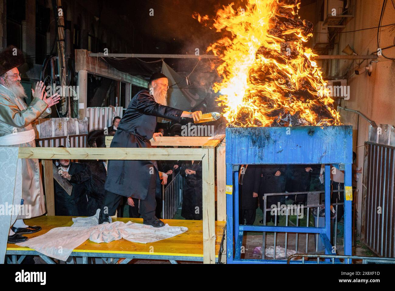 Grand Rabbi of Lelov Hasidic court, applauds one of the participants during the ceremony of lighting the Lag Ba'omer bonfire. Lag Ba'omer is a Jewish traditional event that occurs on the 33rd day of the counting of the Omer. Two main historical events are related to Lag Baomer. It is believed to be the day of the death of Rabbi Shimon Bar Yochai (also known as RASHBI), an important sage in ancient Judaism. In modern days it is considered as a celebration to commemorate the victory of the Bar Kokhba revolt, an armed rebellion initiated by the Jews in Judea against the Roman Empire in 132 CE. Du Stock Photo