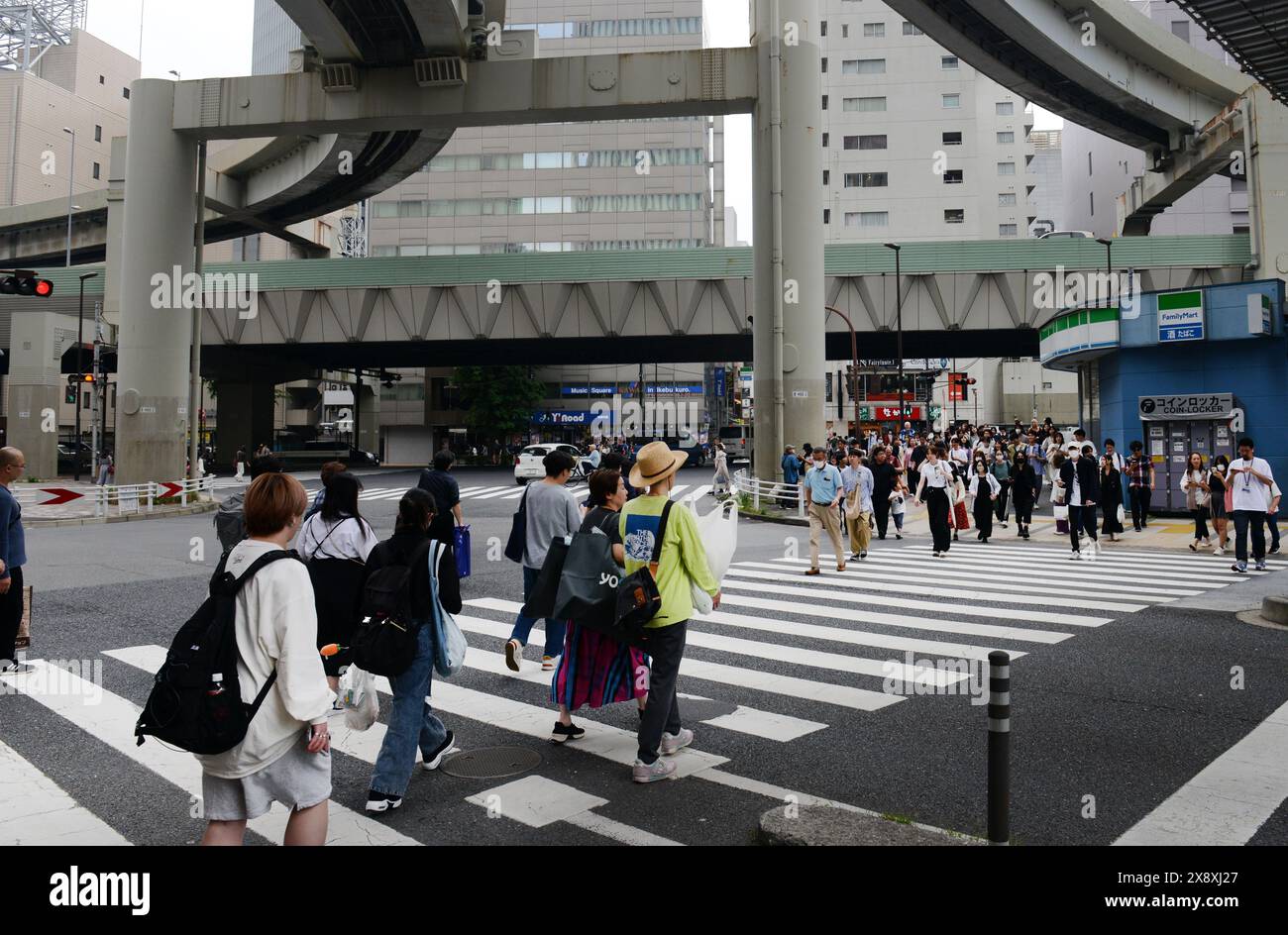 Pedestrians crossing the street in Ikebukuro, Tokyo, Japan