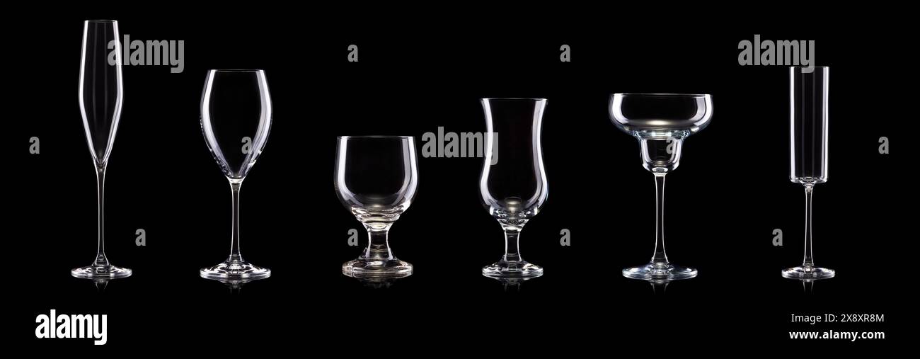 Set of different empty glasses for drinks and cocktails on black background with clipping path. Stock Photo