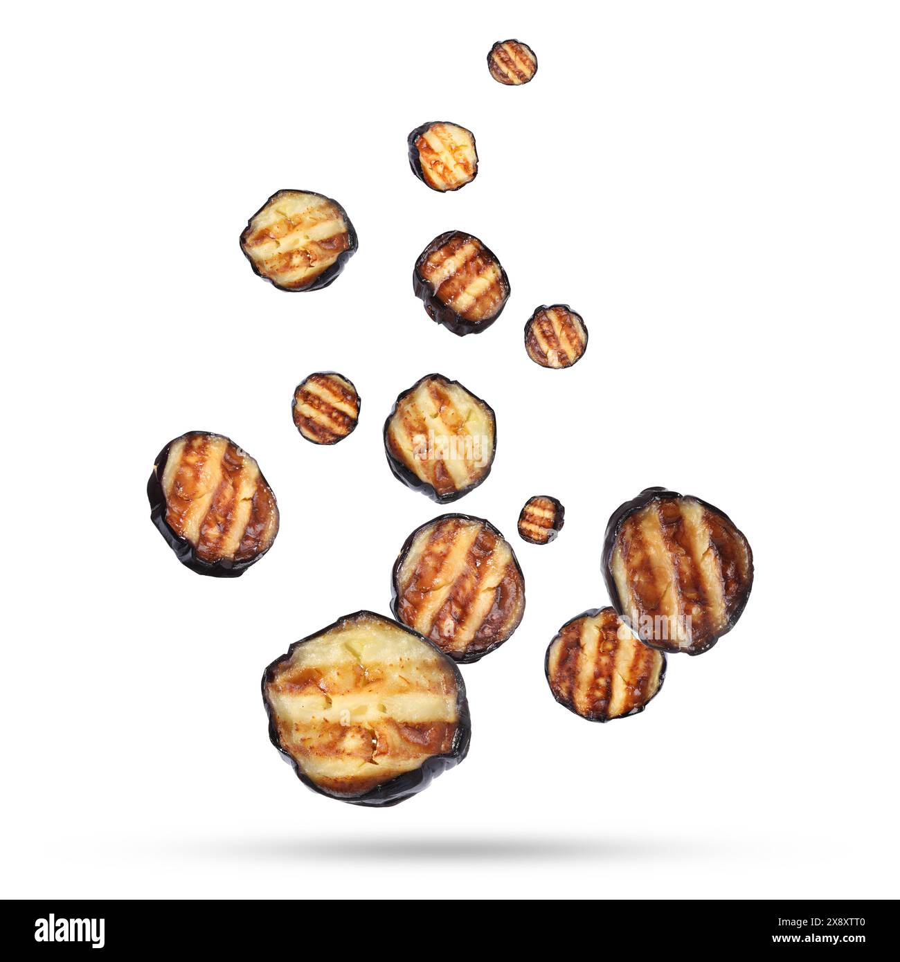 Slices of grilled eggplants in air on white background Stock Photo