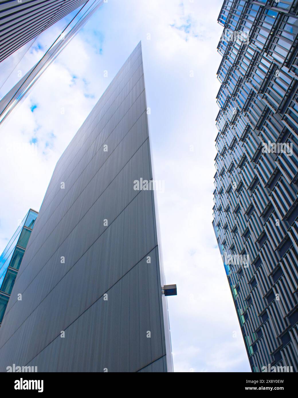 Striking modern architecture in London with sharp geometric forms and sleek glass facades reaching towards the sky. Stock Photo