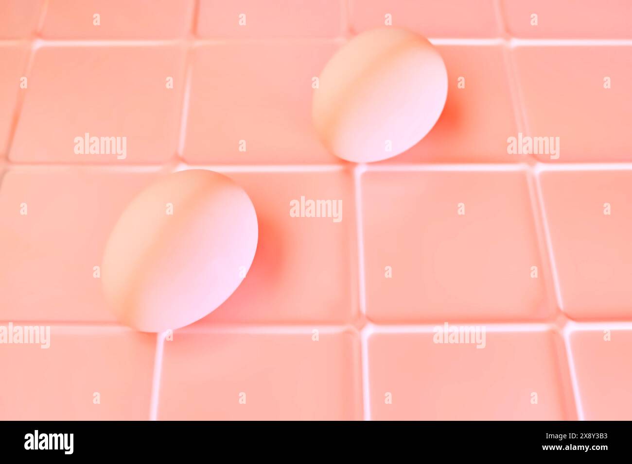 Two chicken bird eggs on a pink plastic checkered shelf in the fridge Stock Photo