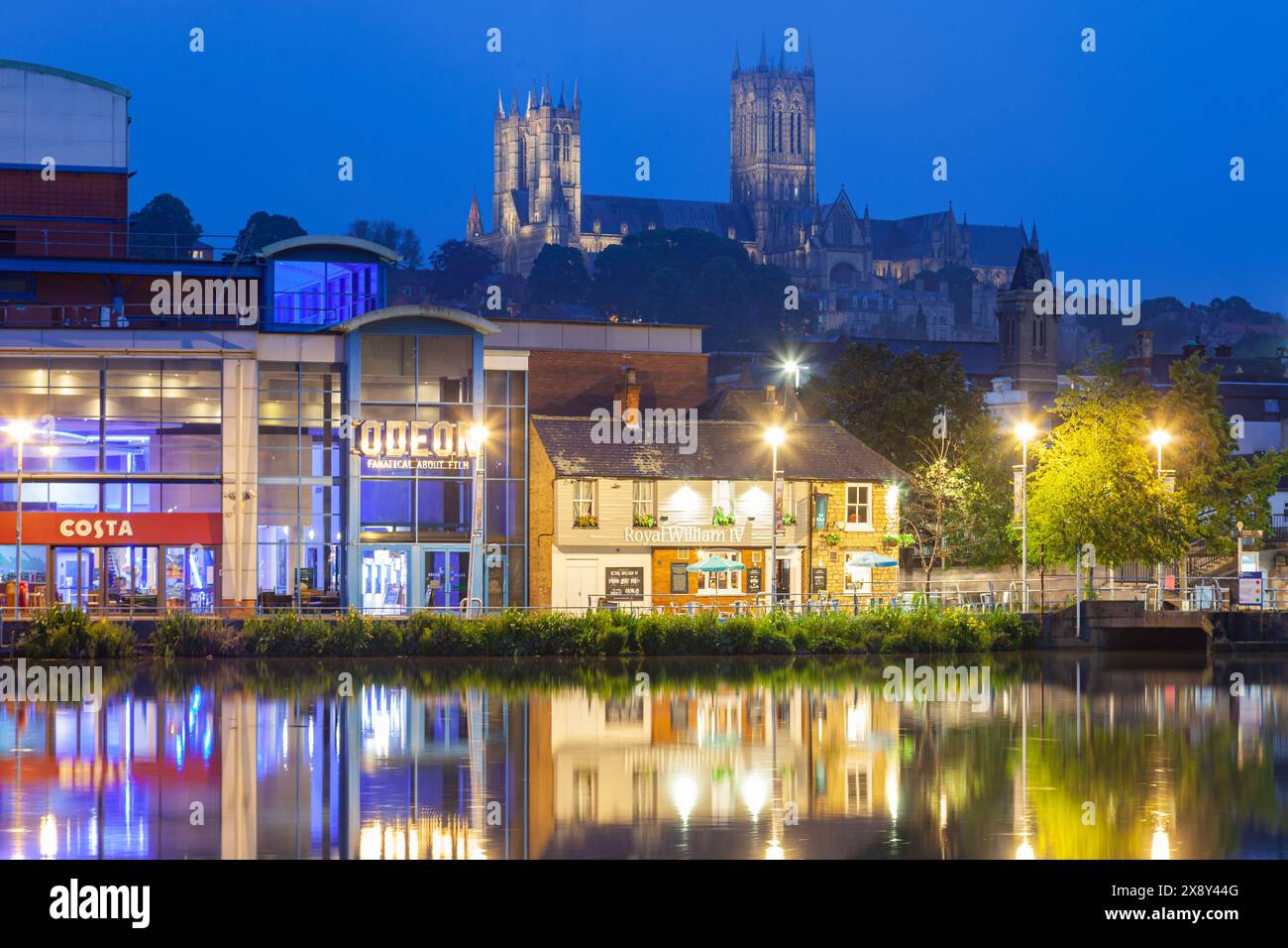 Night falls on Brayford Pool in Lincoln, England. Lincoln cathedral dominates the skyline. Stock Photo