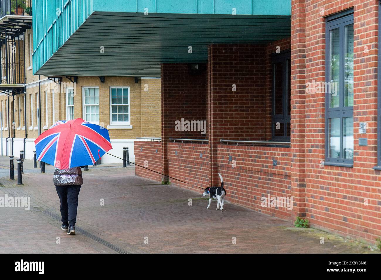 Windsor, UK. 28th May, 2024. A lady walks a dog next to the River Thames. It was a wet and rainy morning in Windsor, Berkshire today. Credit: Maureen McLean/Alamy Live News Stock Photo
