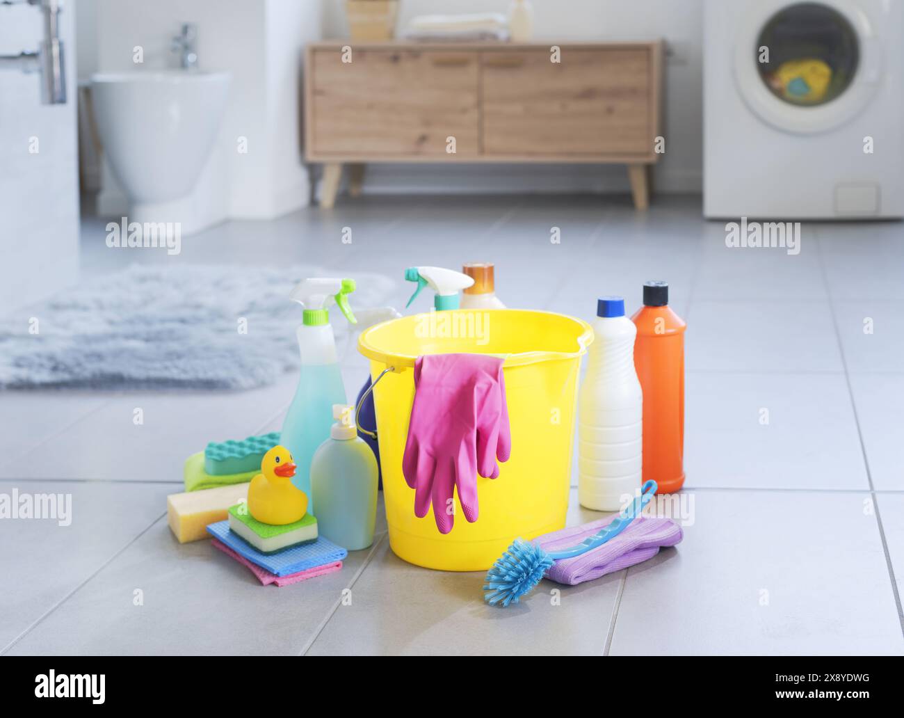 Assorted cleaning supplies and detergents on the bathroom floor