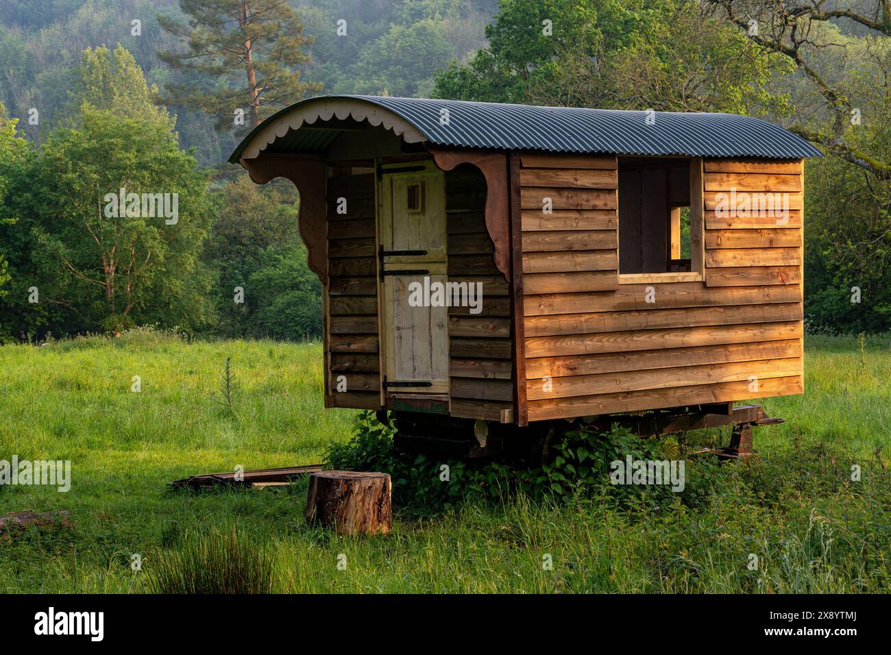 Vintage shepherds hut in a rural setting lit by warm afternoon sunlight Stock Photo