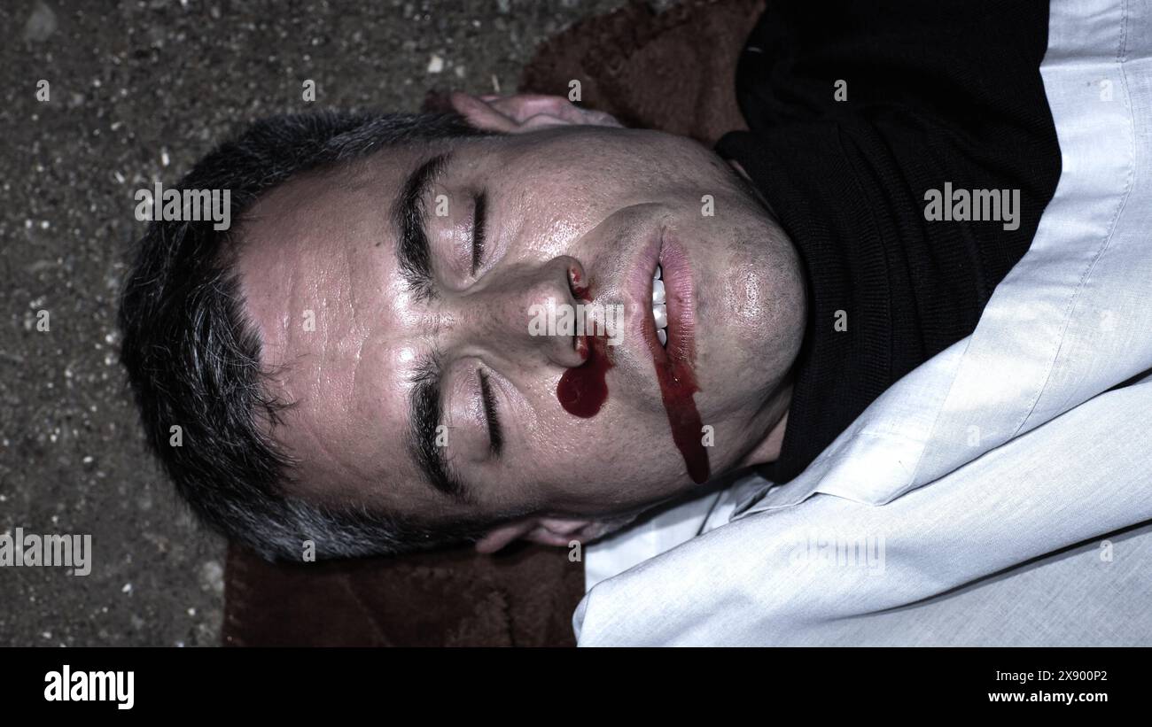 Evidence Pictures Taken by Forensics on Crime Scene: Close Up Of the Victim's Body State as Found by the Police After Being Shotin a Gang War Fight .Photo of the Corpse Documented for the Case File Stock Photo