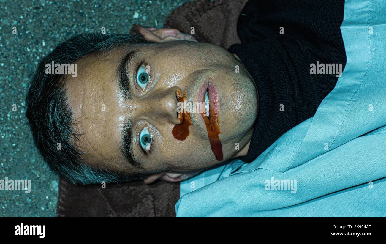 Realistic Police Case File Photo: Close Up Shot of the Face of a Dead Victim of Case of Mugging Gone Wrong. Young Man Falls Victim to Street Violence. Example of Forensics Photography Stock Photo