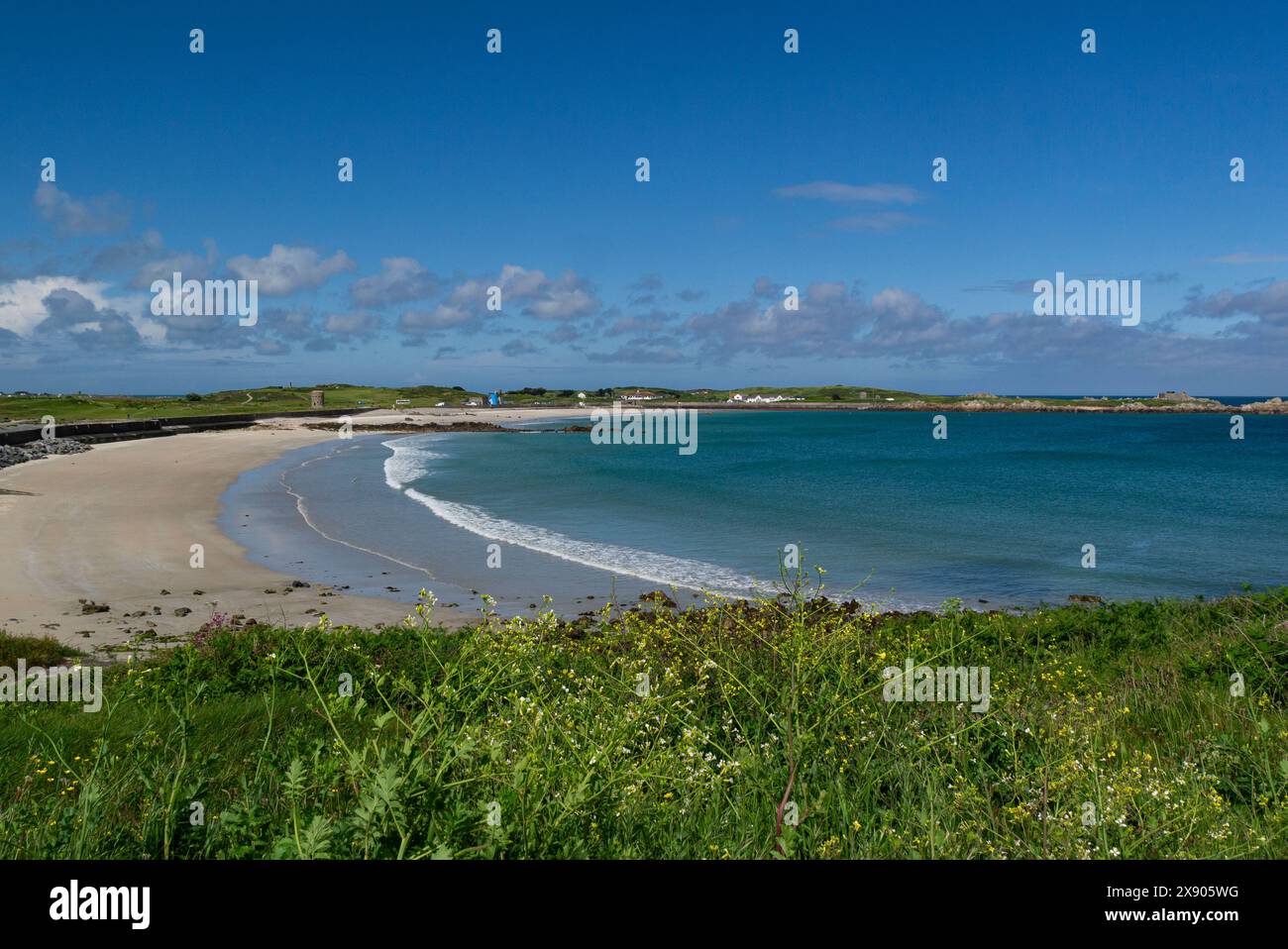 View across fine white sand of L'Ancresse and Pembroke Beach L'Ancresse