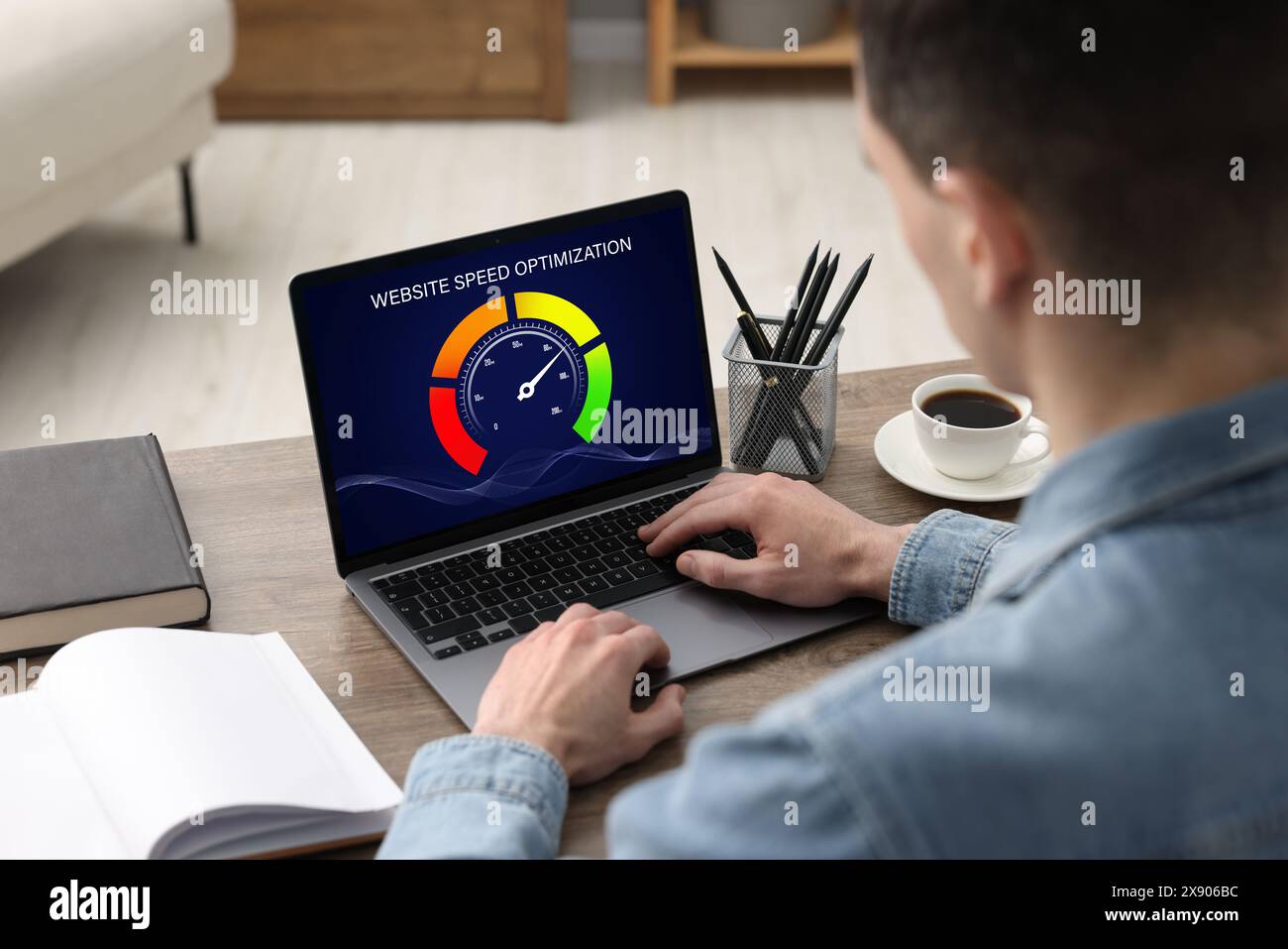 Website speed optimization. Man using laptop at table, closeup Stock Photo