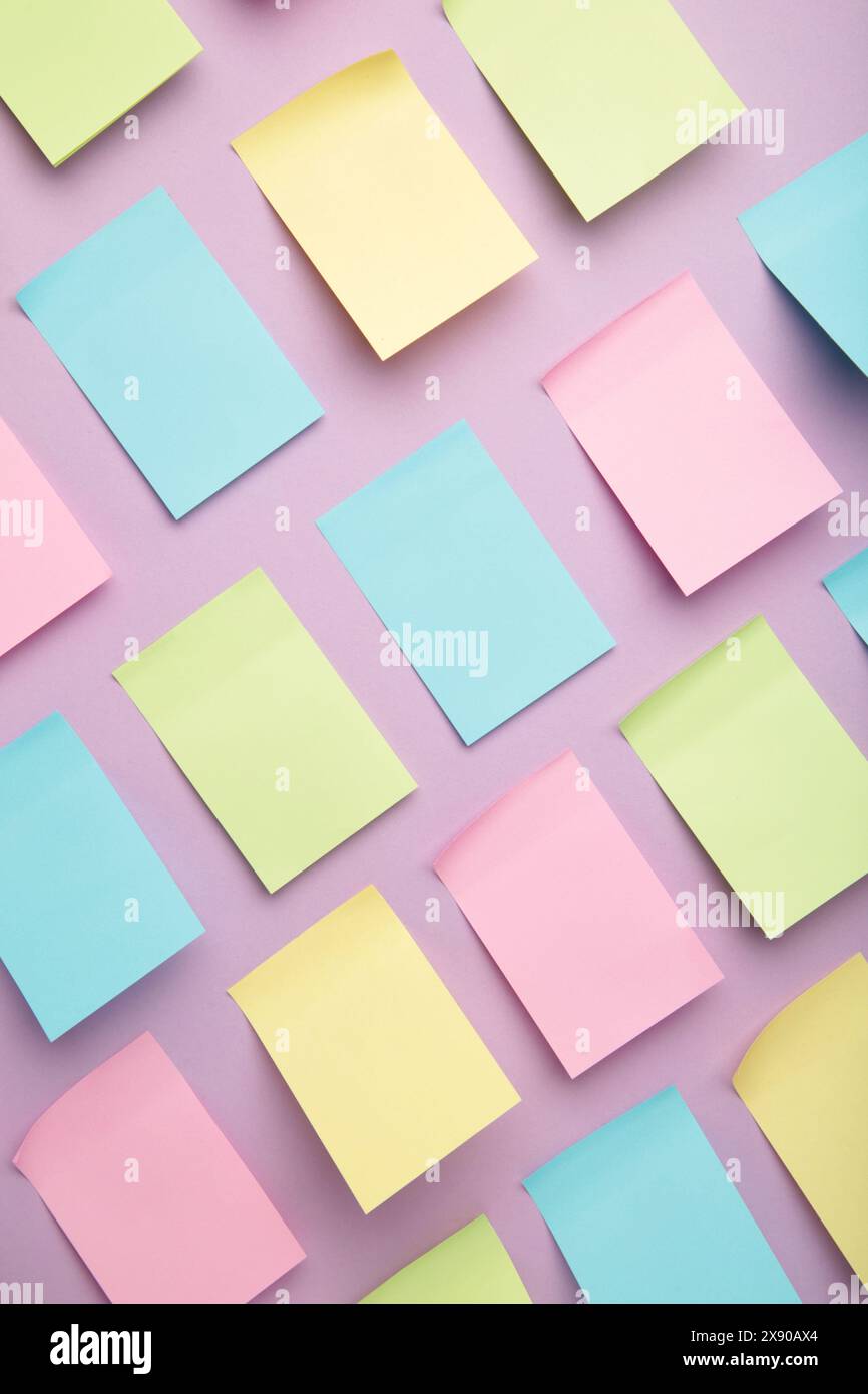Colorful sticky notes on purple background. Top view Stock Photo