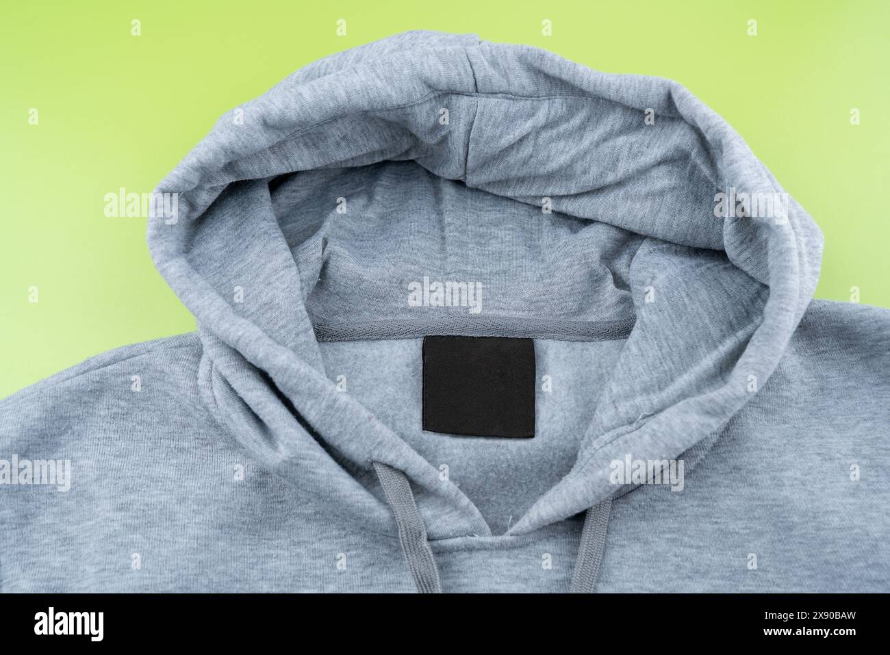 Empty black label on gray sweatshirt for logo, size and info. Blank mockup for your design Stock Photo