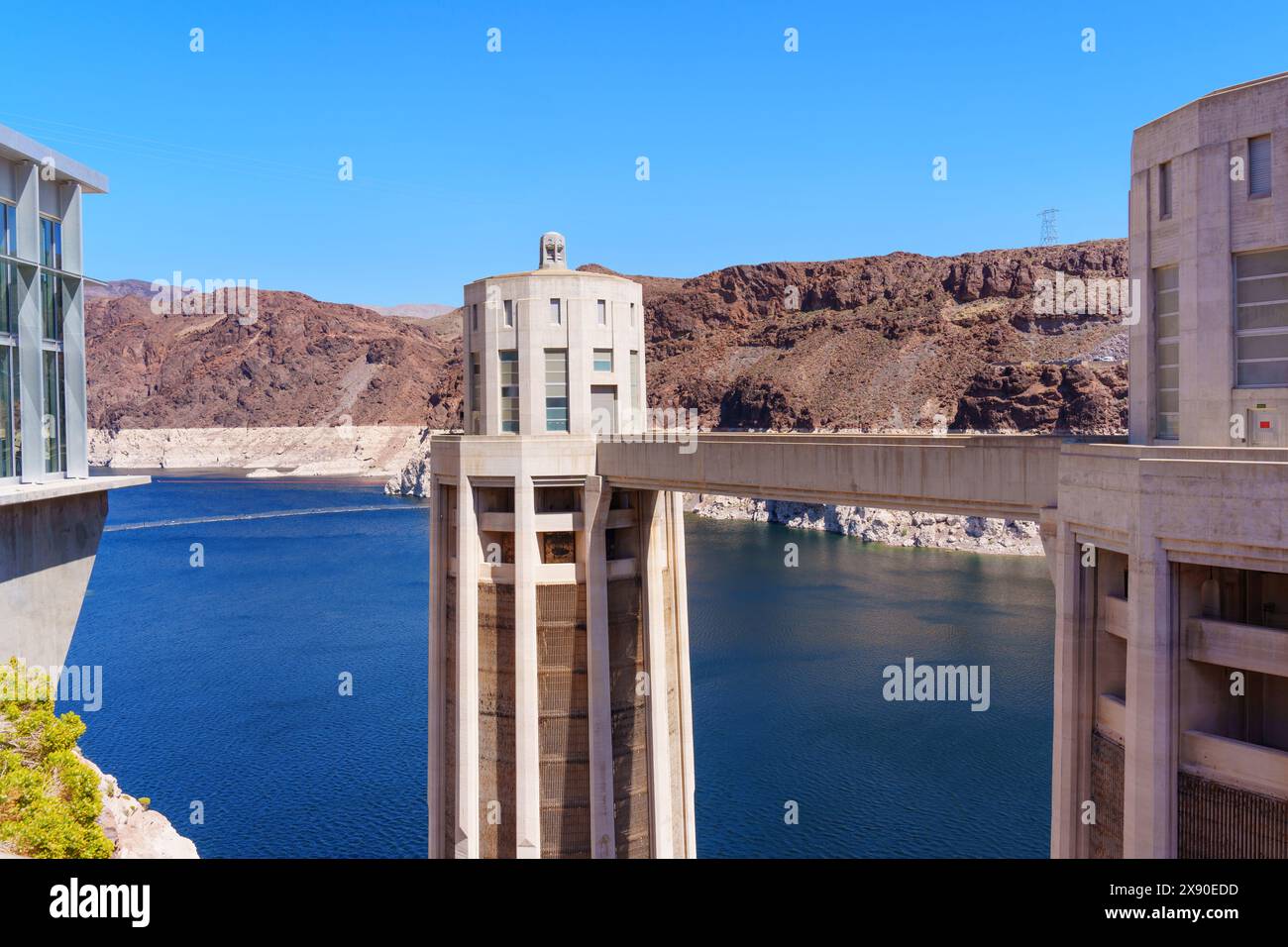Daytime Close-up View of the Hoover Dam’s Water Intake Towers Set Against Rugged Terrains and Clear Blue Sky. Stock Photo