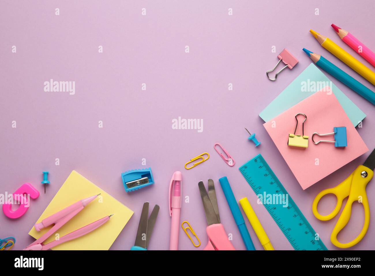 Different stationery on purple background, flat lay with space for text. Stock Photo