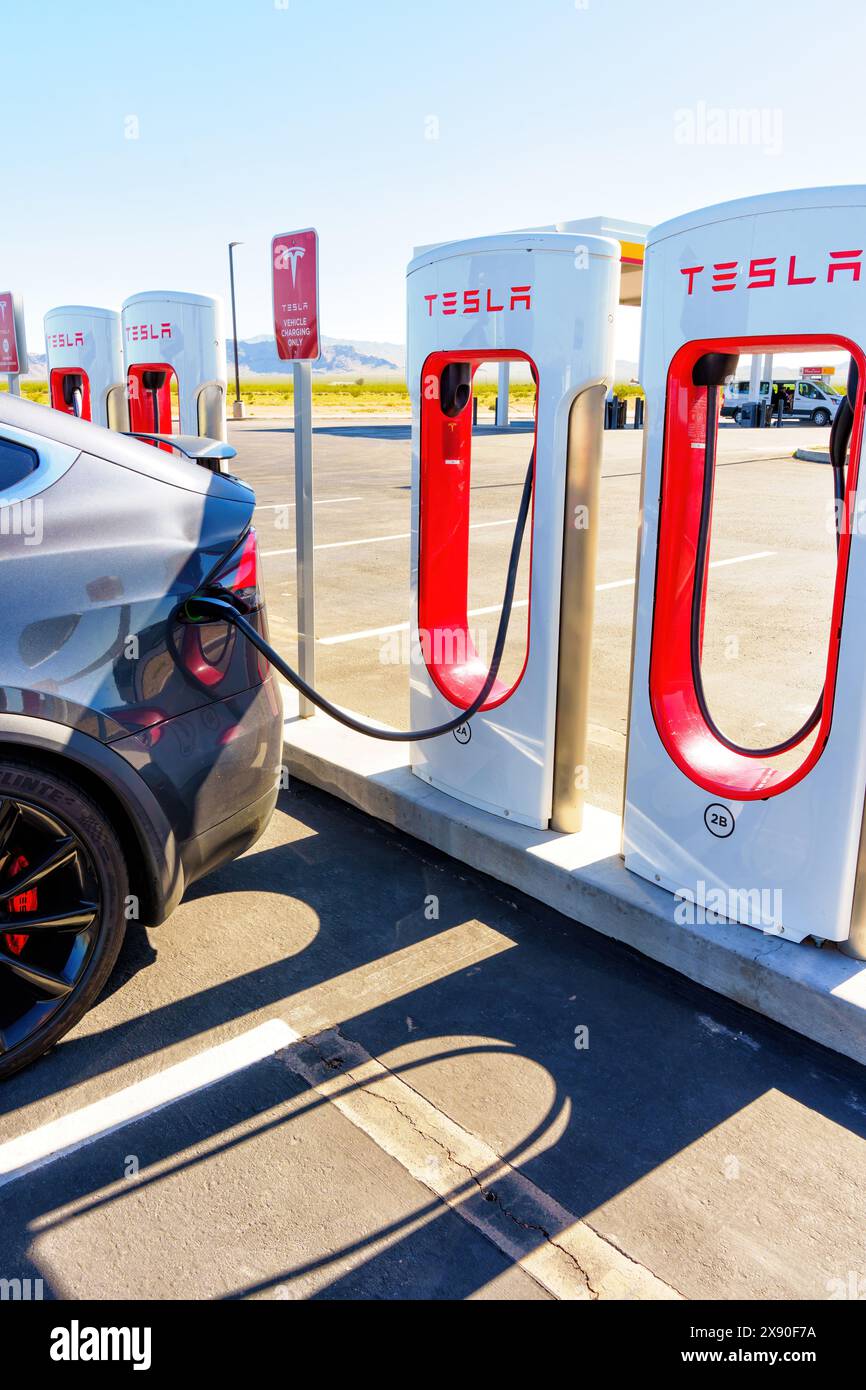 White Hills, Arizona - April 14, 2024: Close-up View of a Tesla Electric Car Being Charged at a Supercharger Station Stock Photo
