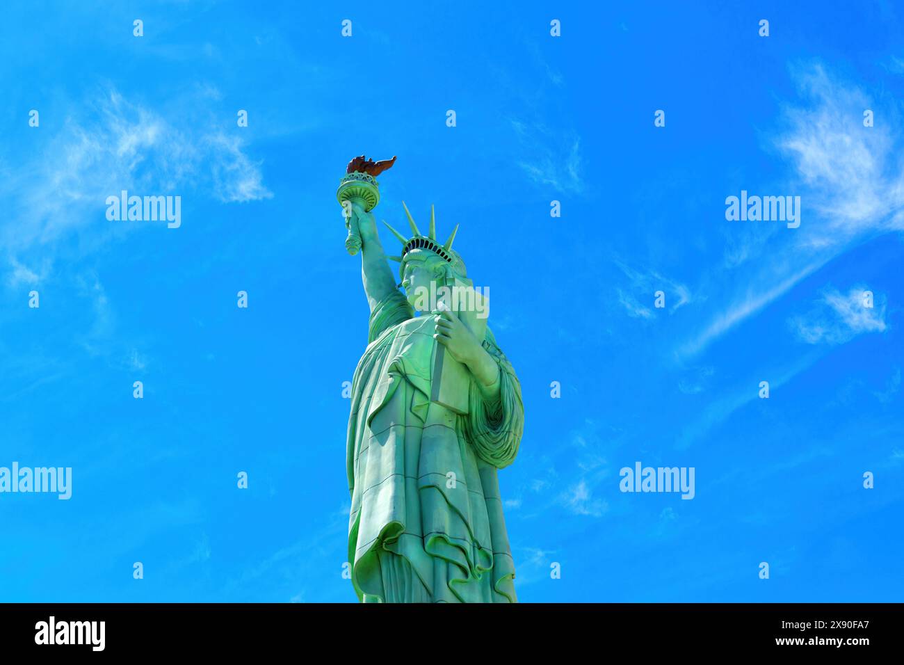Las Vegas, Nevada - April 14, 2024: Upward perspective of the Statue of Liberty replica set against a clear blue sky Stock Photo