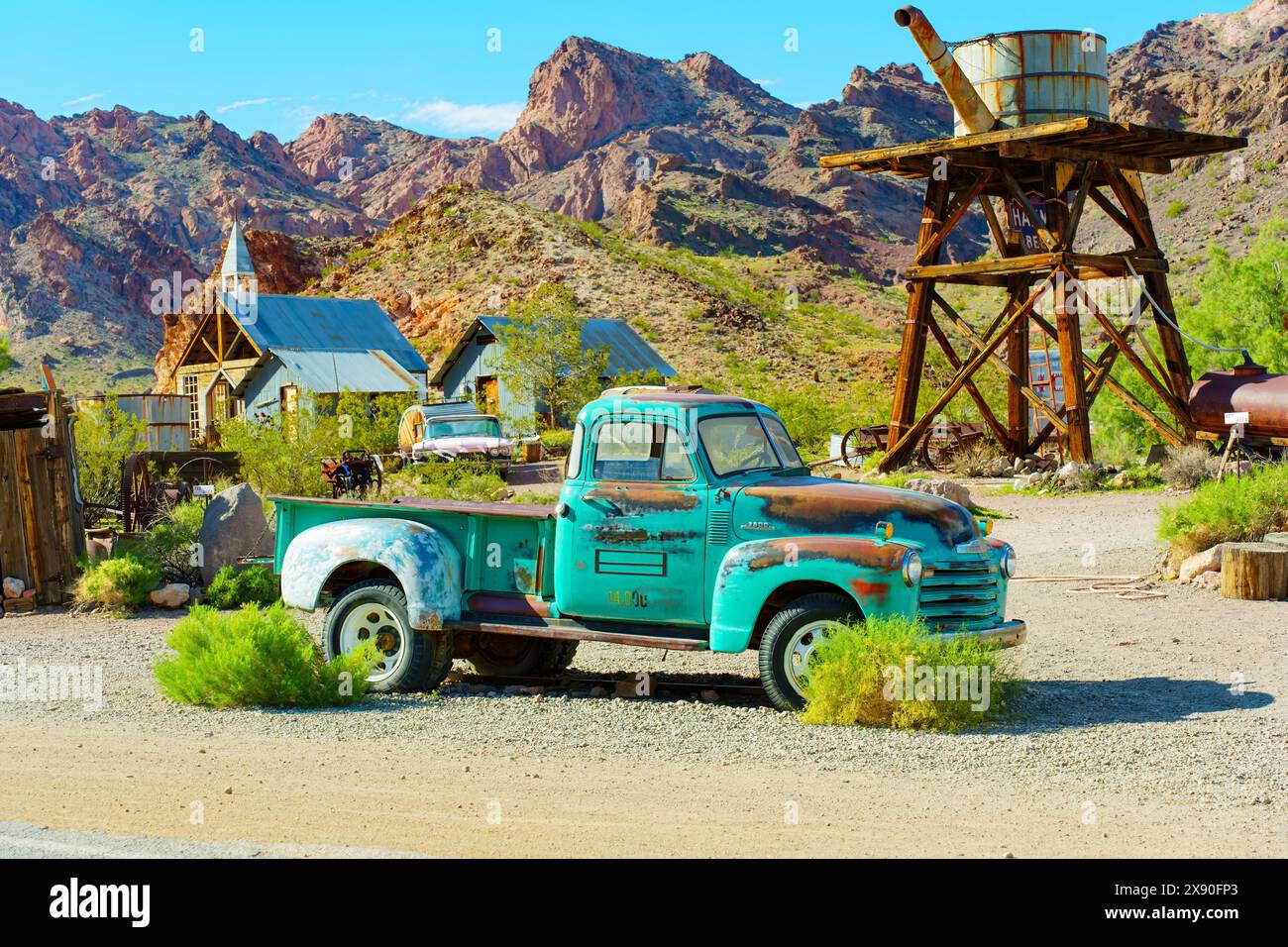 Nelson, Nevada - April 15, 2024: Old rusted Chevrolet pickup truck parked in front of the vintage buildings and structures of an abandoned gold mining Stock Photo