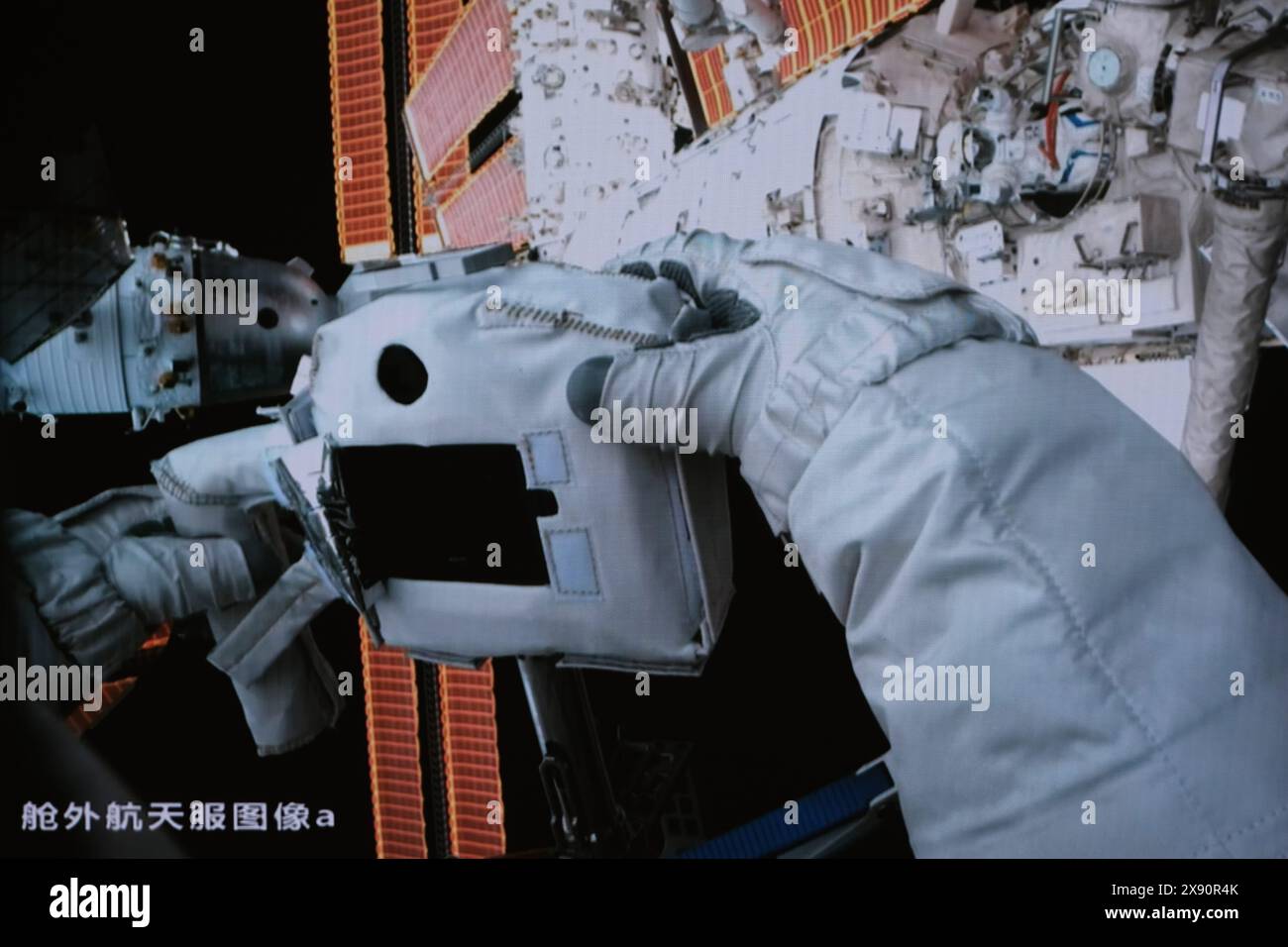 Beijing, China. 28th May, 2024. This screen image captured at Beijing Aerospace Control Center on May 28, 2024 shows Shenzhou-18 astronaut Ye Guangfu taking a photo of Li Guangsu during extravehicular activities. The Shenzhou-18 crew members on board China's orbiting space station completed their first spacewalk on Tuesday, according to the China Manned Space Agency. Credit: Li Jie/Xinhua/Alamy Live News Stock Photo