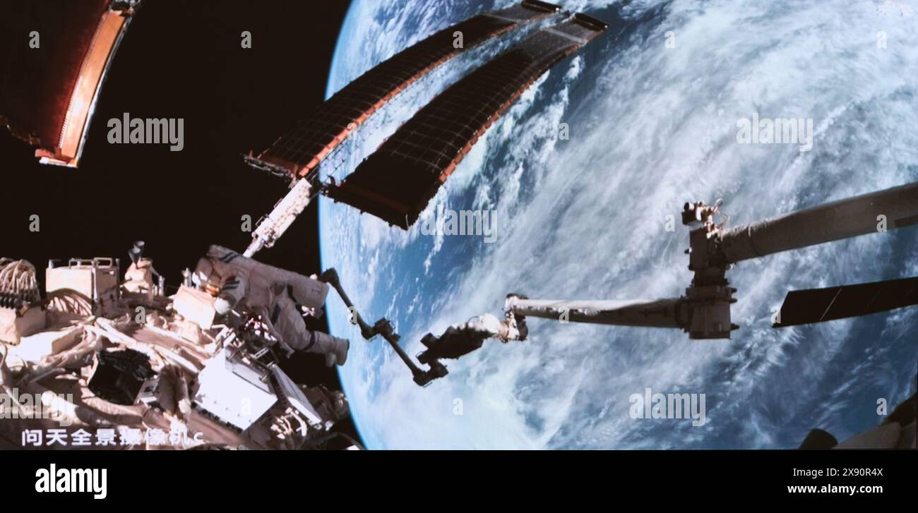 Beijing, China. 28th May, 2024. This screen image captured at Beijing Aerospace Control Center on May 28, 2024 shows Shenzhou-18 astronaut Li Guangsu performing extravehicular activities. The Shenzhou-18 crew members on board China's orbiting space station completed their first spacewalk on Tuesday, according to the China Manned Space Agency. Credit: Li Jie/Xinhua/Alamy Live News Stock Photo
